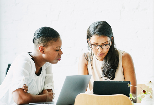 Women having in a meeting by a laptop